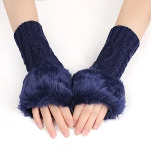 Detail of navy blue knit fingerless gloves with luxurious faux fur trim for winter warmth.