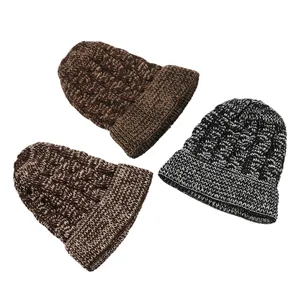 Set of three chunky cable knit beanie hats in brown and black-white melange textures.