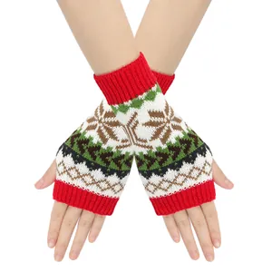 Detailed close-up of Christmas snowflake pattern on red and white knitted gloves.