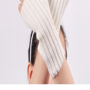 Close-up detail of knitted fingerless arm warmers showing vertical rib texture.