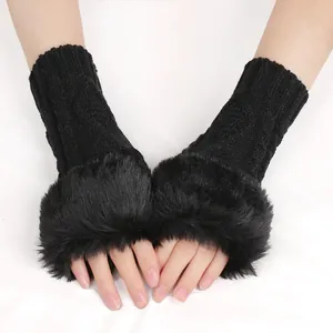 Close-up of black knitted fingerless gloves with soft faux fur trim and diamond pattern.