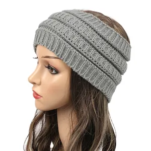 Side view of a grey knitted winter headband ear warmer on a mannequin head model