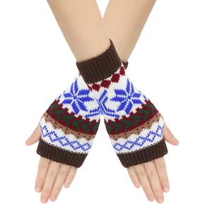 Detailed close-up showing the festive Christmas snowflake pattern on knitted fingerless gloves.