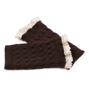 Detail view of dark brown cable knit leg warmers with delicate white lace trim