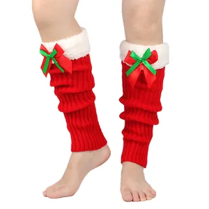 Red Christmas knitted leg warmers with white plush trim and festive bow detail.
