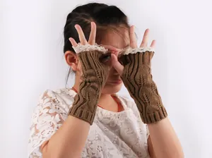 Winter brown knitted fingerless gloves with elegant lace trim details on child model
