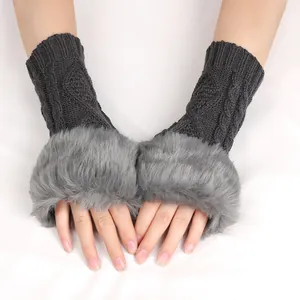 Macro view showing the soft faux fur trim and cable-knit texture of these grey wrist warmers.