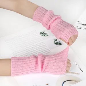 Close-up of pink knitted fingerless gloves showing high elasticity and texture