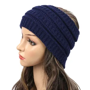 Side detail view of a navy blue wide knitted headband for women worn on a mannequin