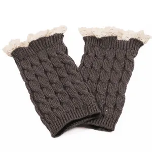 Detail view of dark brown knitted boot toppers with delicate cream lace trim detail