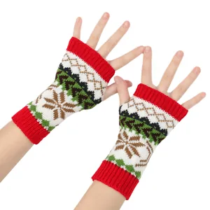 Close-up of Christmas knit fingerless gloves with snowflake and tree patterns