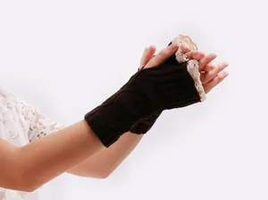 Detail of brown knitted fingerless gloves with elegant cream lace trim for women