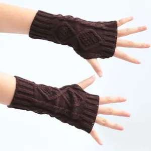 Close-up detail of dark brown cable knit fingerless gloves showing warm texture