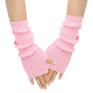 Macro detail view of soft pink ribbed knit fingerless gloves for women, worn on hands