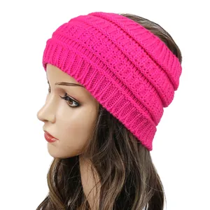 Detailed side view of a hot pink chunky knitted winter headband worn on a mannequin head