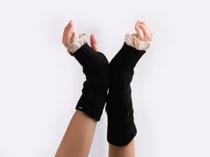 Elegant black cable-knit fingerless gloves with decorative beige lace trim for women