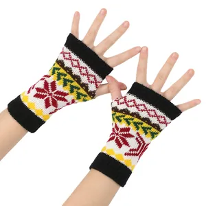 Detailed view of colorful knitted Christmas snowflake fingerless gloves on hands