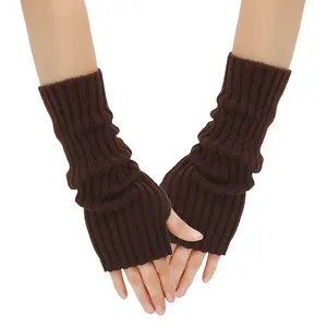 Close-up detail of dark brown knitted fingerless arm warmers worn on human hands