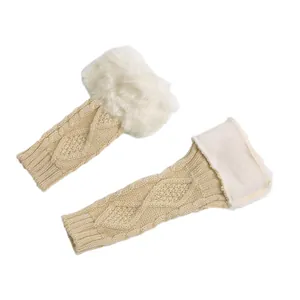 Detailed view of beige cable knit arm warmers featuring soft white faux fur trim details.