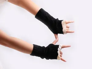 Detailed close-up view of black cable knit fingerless gloves with elegant lace trim