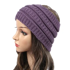 Close-up view of purple knitted wide headband showing detailed cable knit texture