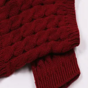 Macro detail showing the intricate red cable-knit texture of these acrylic warm leg warmers