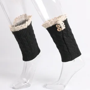 Close-up of cable knit boot cuffs with beige lace trim and wooden buttons on mannequin