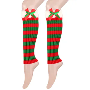 Detail of festive Christmas knit leg warmers with red and green stripes and cute bows