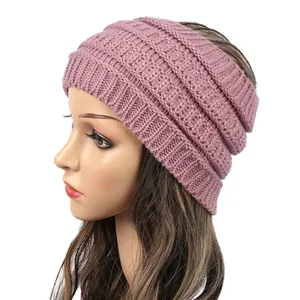 Side detail of pink chunky knit ponytail headband showing texture and fit on head
