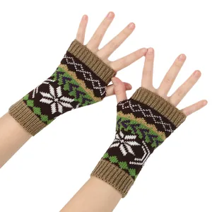 Close-up of knit fingerless gloves with Christmas snowflake pattern on white background