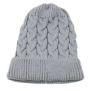 Close-up showing the intricate grey cable-knit texture of the warm winter beanie hat