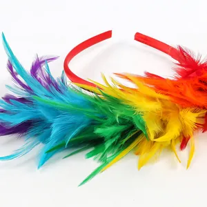 Close-up detail showing the vibrant textures of rainbow feathers on a festive red headband