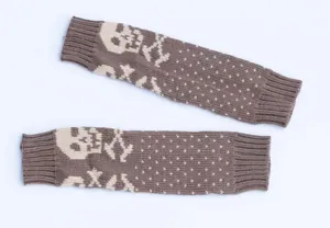 Macro view of skull pattern on warm brown knitted fingerless arm warmers for winter.