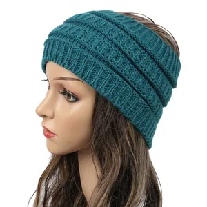 Close-up of dark teal wide knitted winter headband showing chunky ribbed texture on mannequin
