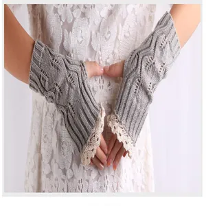 Detailed view of gray knit fingerless arm warmers with delicate lace trim detail