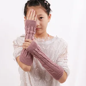 Warm knitted fingerless arm warmers with cable stitch pattern for winter fashion accessory.