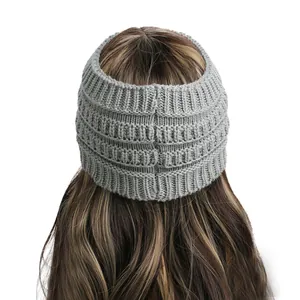 Macro detail of gray knitted headband showing the thick ribbed texture and ponytail fit