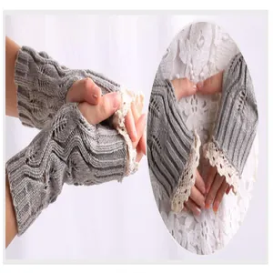 Close-up of grey knitted fingerless gloves with elegant cream lace trim detail.
