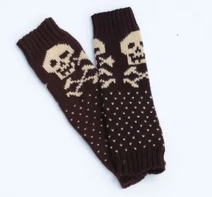 Close-up of knitted fingerless arm warmers with brown skull and crossbone pattern.