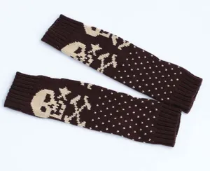 Detailed view of the brown knitted texture and beige skull pattern on the arm warmers