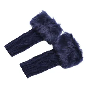 Detailed macro view of navy blue knitted fingerless gloves with soft faux fur cuffs
