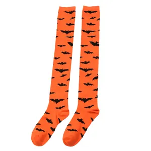 Close-up of orange over-the-knee socks with black bat patterns for Halloween