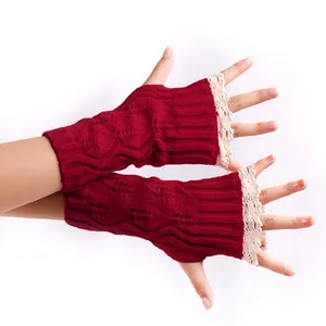 Detailed view of red knitted fingerless gloves with white lace trim for women