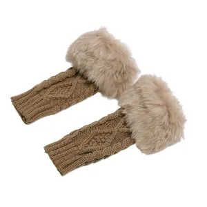 Close-up of knitted fingerless gloves with soft faux fur trim and diamond pattern