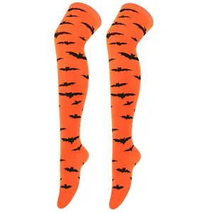Close-up of Halloween orange thigh-high socks with black bat patterns for cosplay.