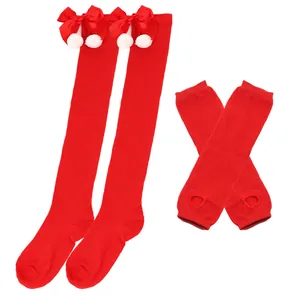 Rote weihnachtliche Overknee-Strümpfe mit Schleifen und fingerlosen Handschuhen