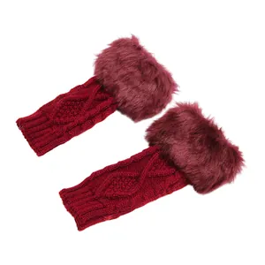 Detailed view of dark red knit arm warmers with plush faux fur trim and cable pattern