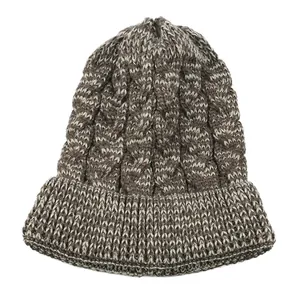 Detailed view of a brown cable knit beanie showing thick texture and a folded brim.