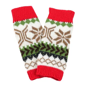 Detailed knit texture of Christmas snowflake fingerless arm warmers in festive colors