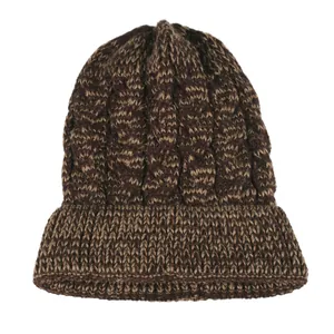 Detailed view of brown cable knit beanie featuring thick texture and pointed top